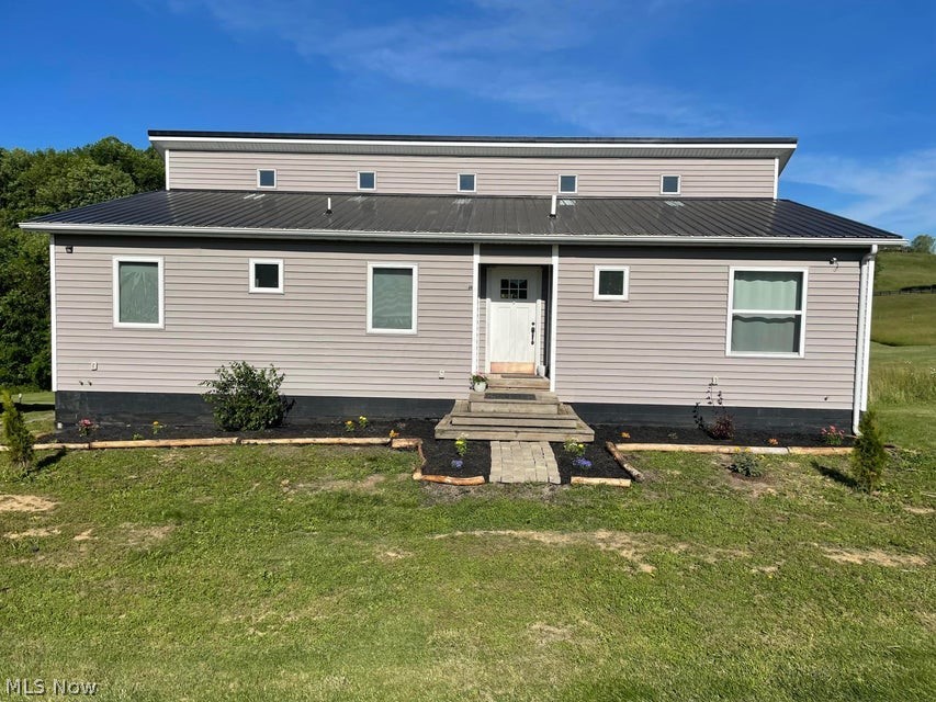 15393 Shade Road Guysville, OH 45735 - Photo 25 of 35 Contemporary-style residence featuring light gray siding with white trim, a dark metal roof, and a prominent front door with multiple glass panes