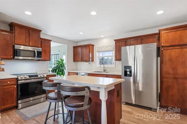 a view of a dining room with furniture and a chandelier