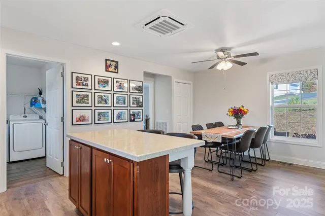 a kitchen with a sink a refrigerator and cabinets
