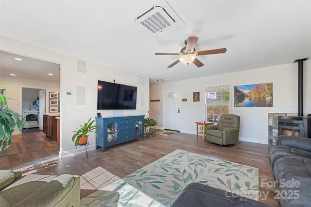 a living room with furniture a fireplace and a flat screen tv