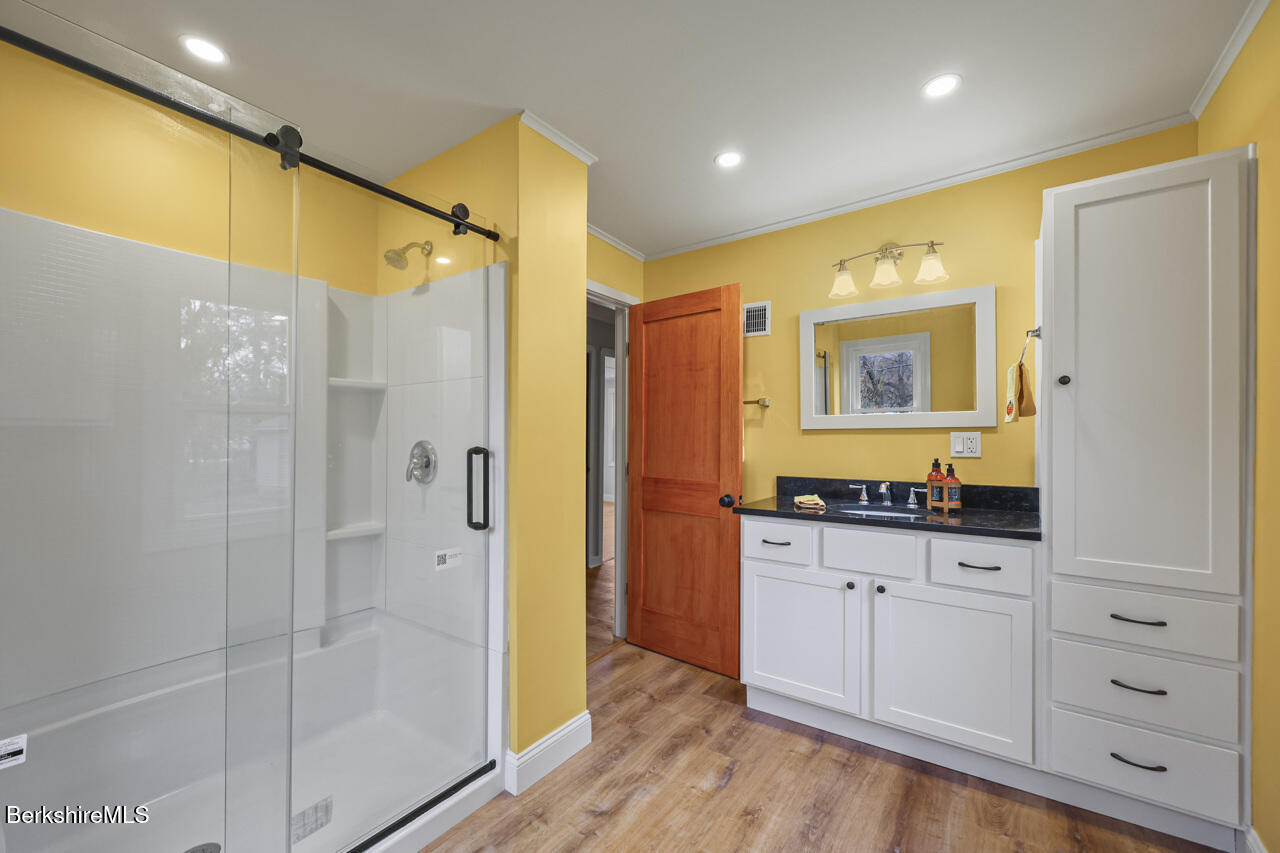 227 Protection Avenue North Adams, MA 01247 - Photo 15 of 25 a bathroom with a granite countertop sink a mirror a shower and a bathtub