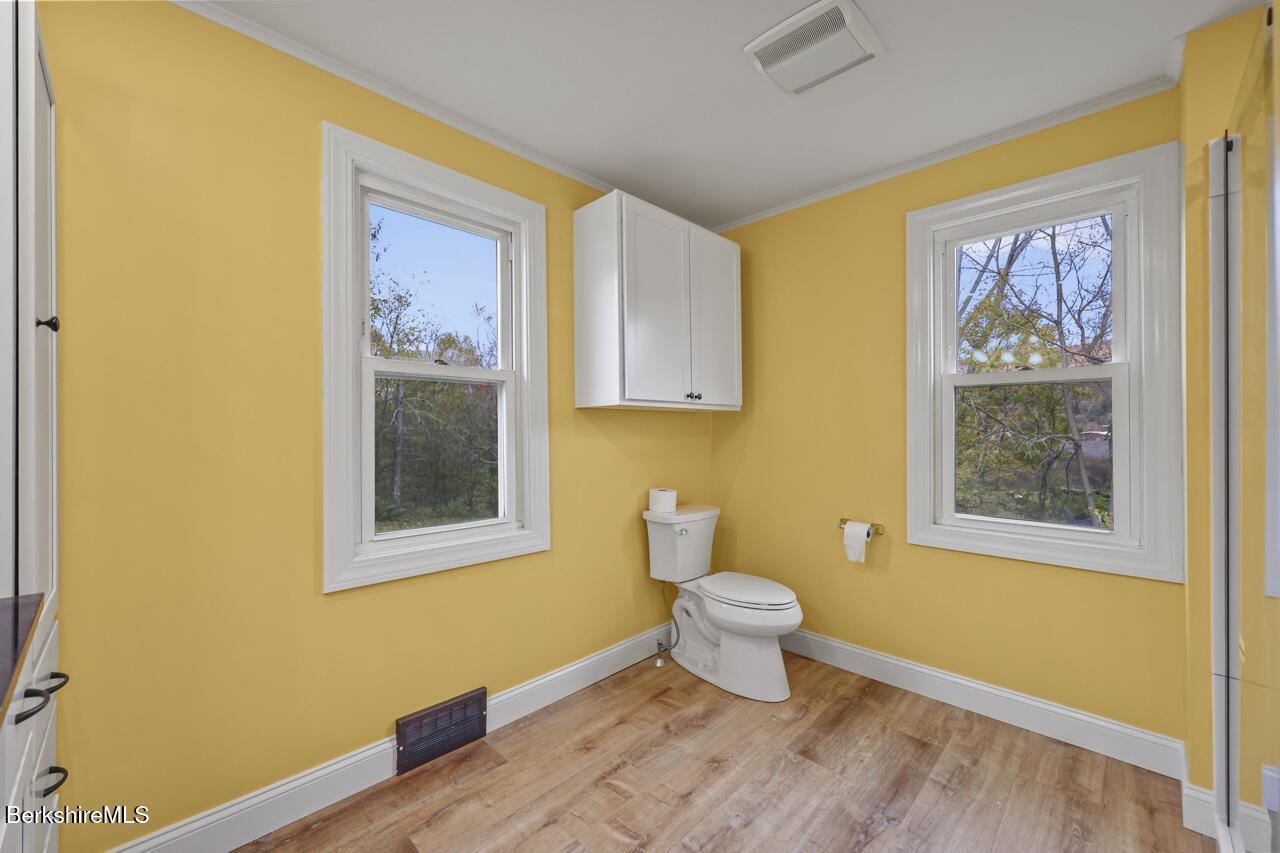 227 Protection Avenue North Adams, MA 01247 - Photo 16 of 25 a bathroom with a toilet sink and mirror