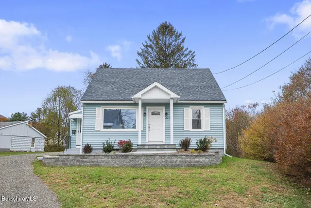 a kitchen with a refrigerator a stove a sink dishwasher and wooden cabinets with wooden floor