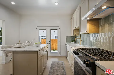 a kitchen that has a lot of cabinets in it