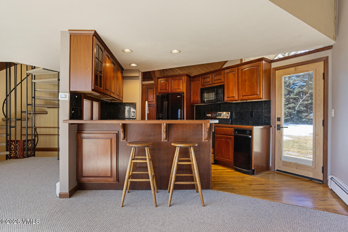 1400 Lions Ridge Loop, Unit A1 Vail, CO 81657 - Photo 11 of 41 a kitchen with stainless steel appliances granite countertop a refrigerator and a stove top oven