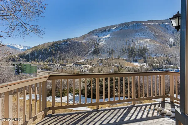 a view of roof deck with wooden fence and deck