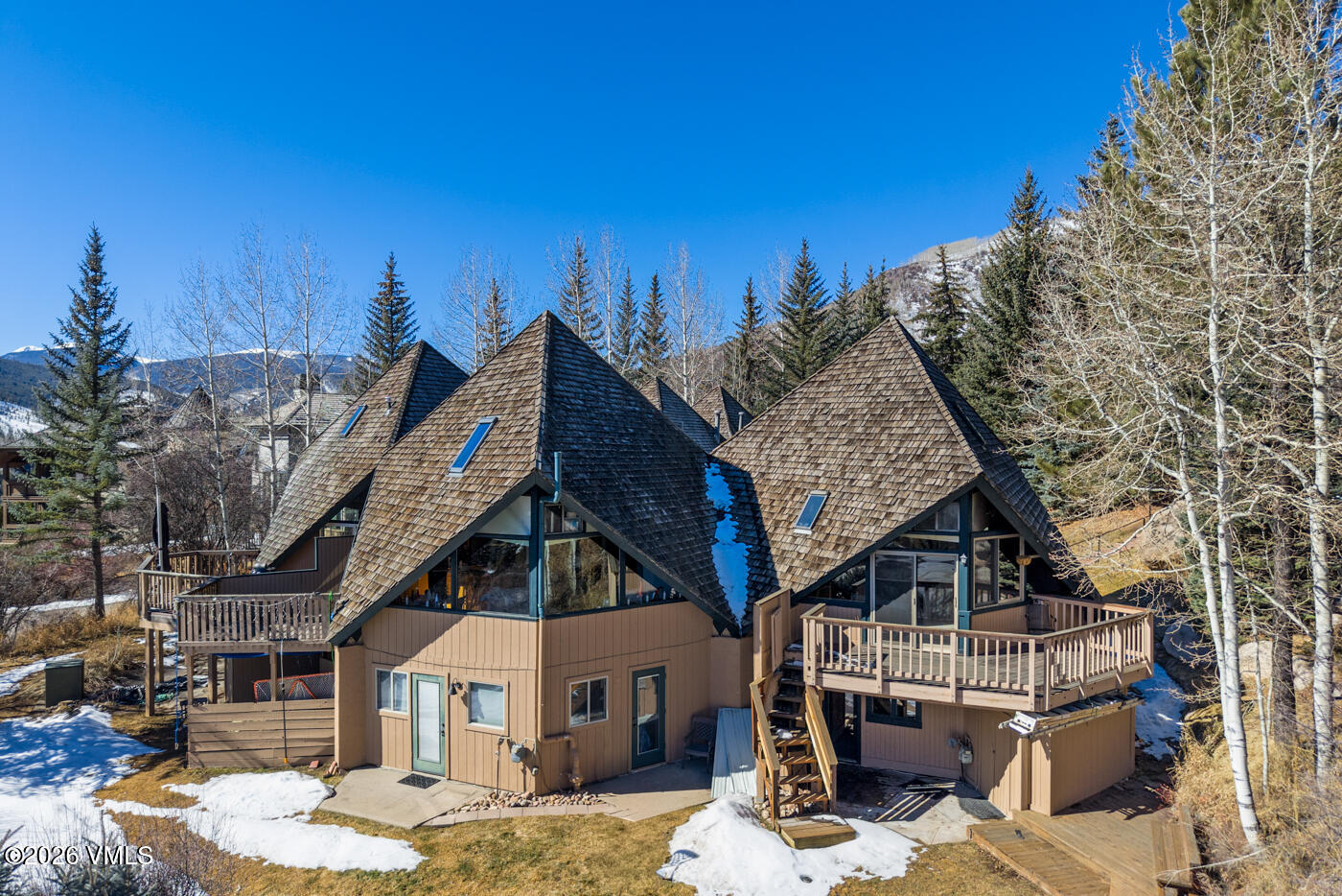 1400 Lions Ridge Loop, Unit A1 Vail, CO 81657 - Photo 36 of 41 a roof deck with table and chairs a barbeque with wooden floor and city view