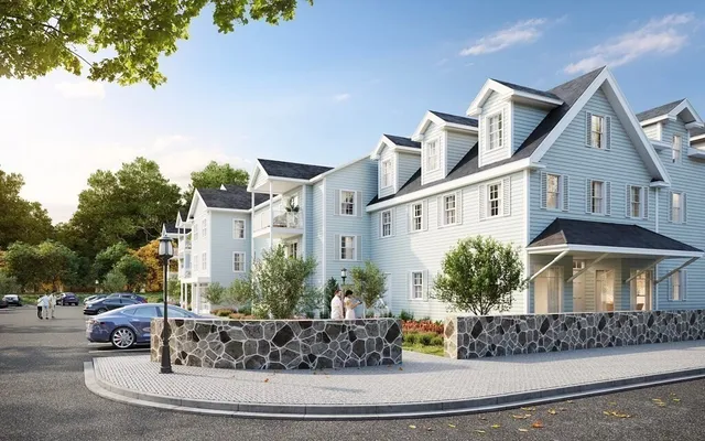 a view of a white house next to a road with large trees