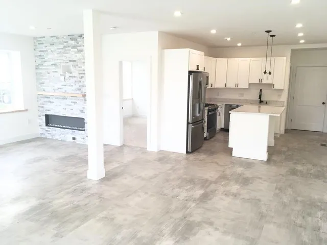 a view of kitchen with refrigerator cabinets and ceiling fan
