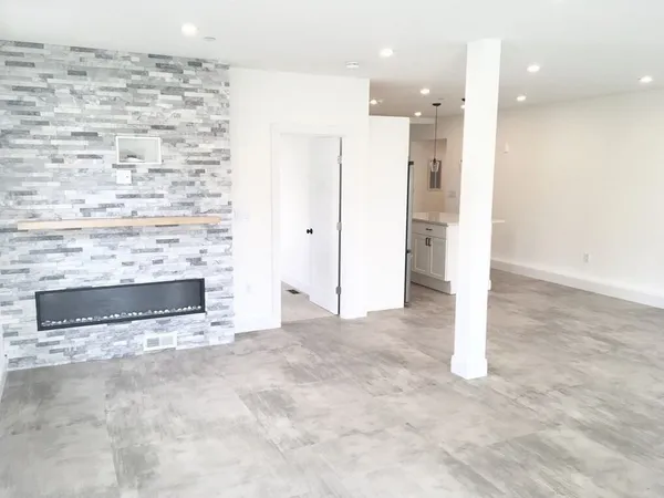 a view of kitchen and empty room