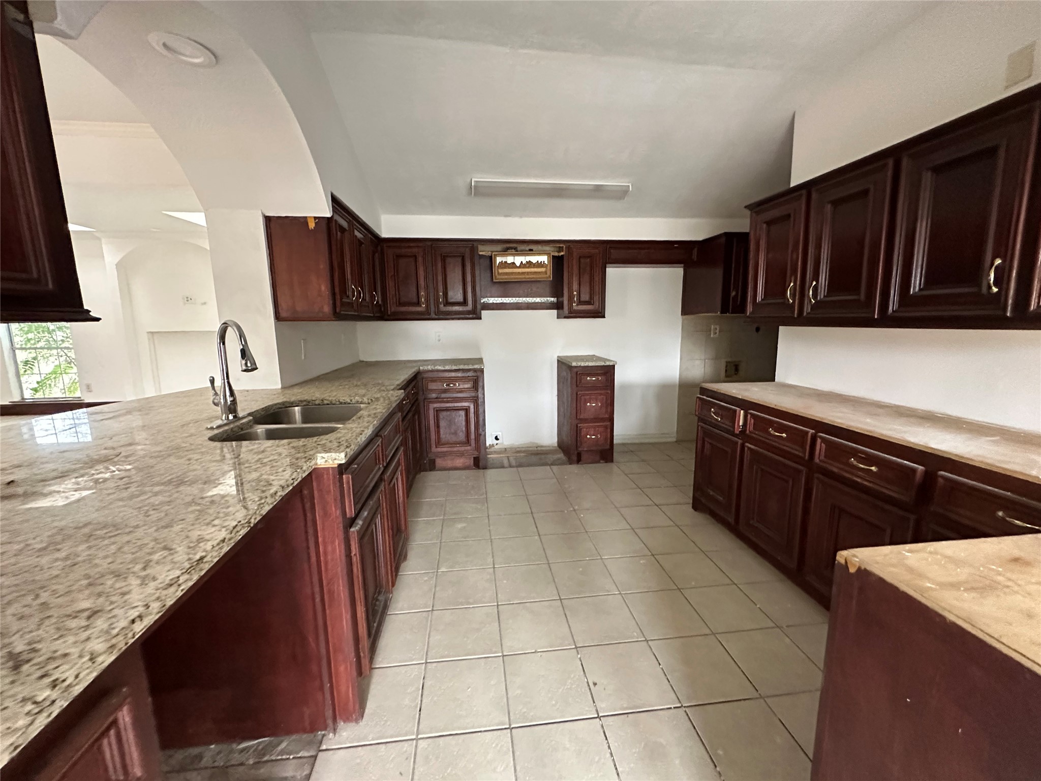 6121 Grace Lane Houston, TX 77021 - Photo 27 of 35 a kitchen with granite countertop a stove a sink and a refrigerator