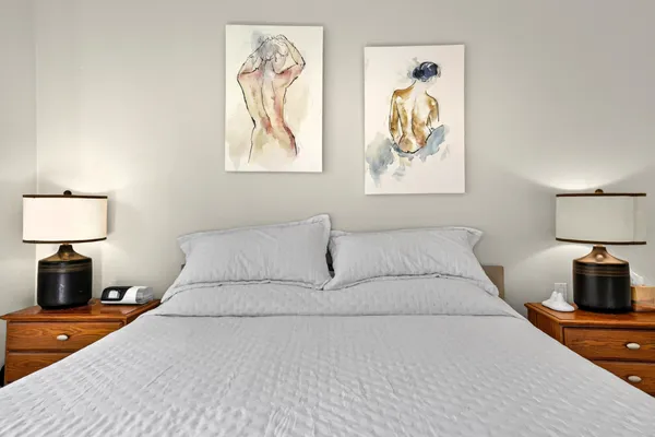 a bedroom with a bed and a lamp