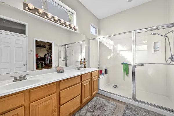 a bathroom with a shower sink and mirror
