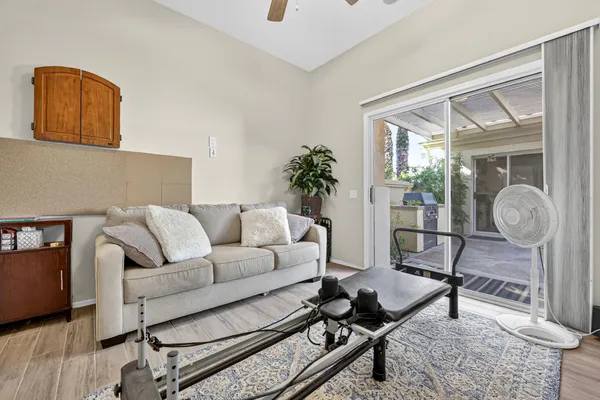 a living room with furniture and wooden floor