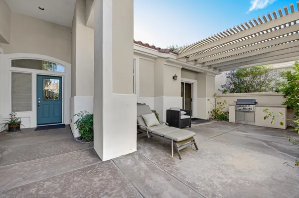 a view of a patio with table and chairs and potted plants
