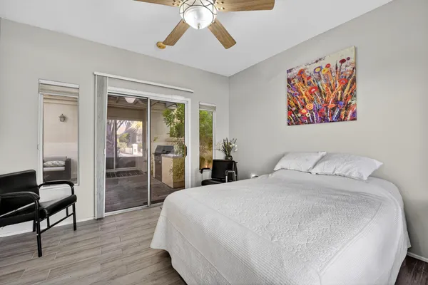 a bedroom with a large bed and a chandelier