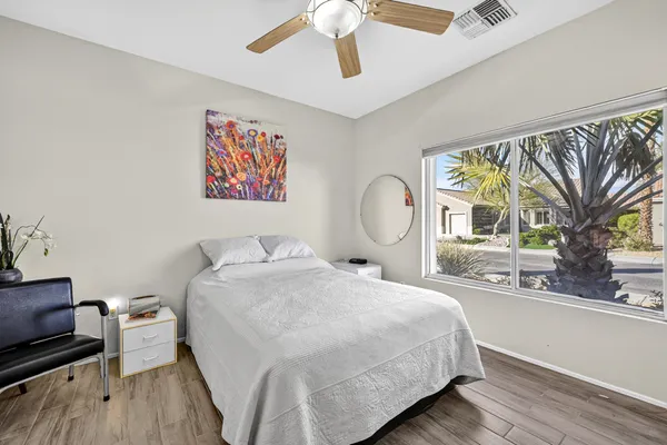 a bedroom with a large bed and a large window