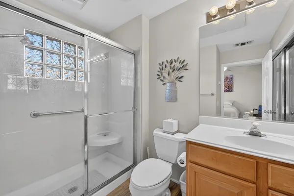 a bathroom with a sink a toilet and shower