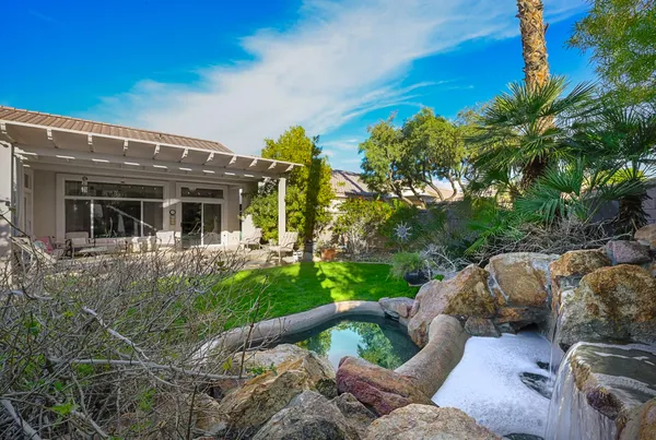 a view of backyard of house with outdoor seating and green space
