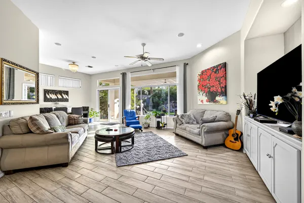 a living room with furniture flat screen tv and a couch