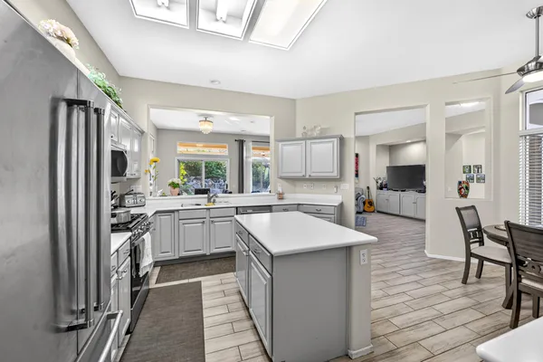 a kitchen with kitchen island a sink stove and refrigerator