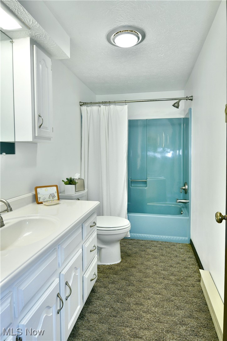 379 Housel Craft Road Bristolville, OH 44402 - Photo 35 of 50 Bathroom with toilet, a textured ceiling, shower / tub combo, and vanity