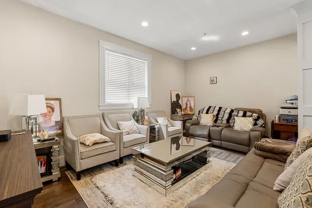 a living room with furniture a rug and a window