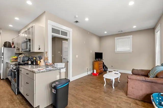 a living room with furniture and a stove