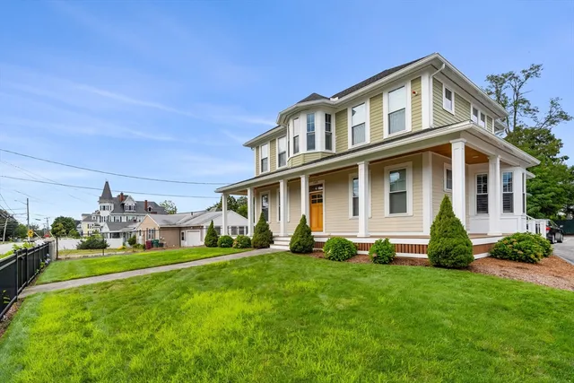 a front view of a house with a yard and porch