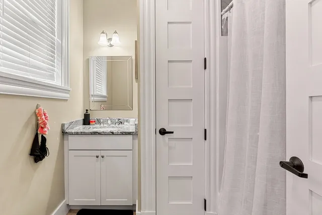 a bathroom with a sink and vanity