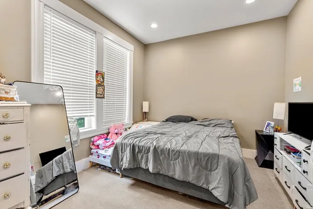 a bedroom with a bed and a tv