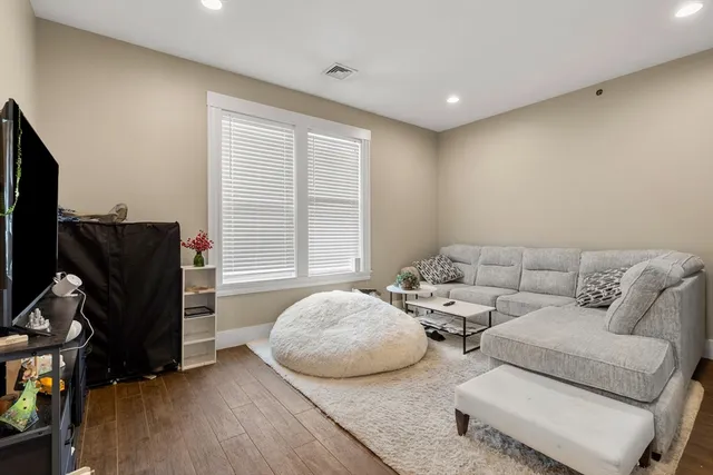 a living room with couches and a flat screen tv