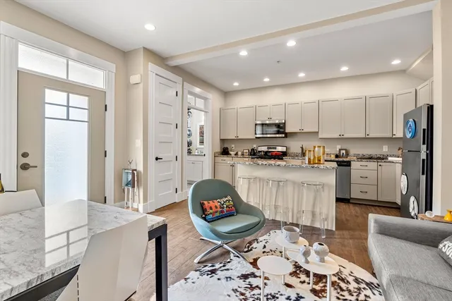 a kitchen with stainless steel appliances granite countertop a refrigerator sink and stove