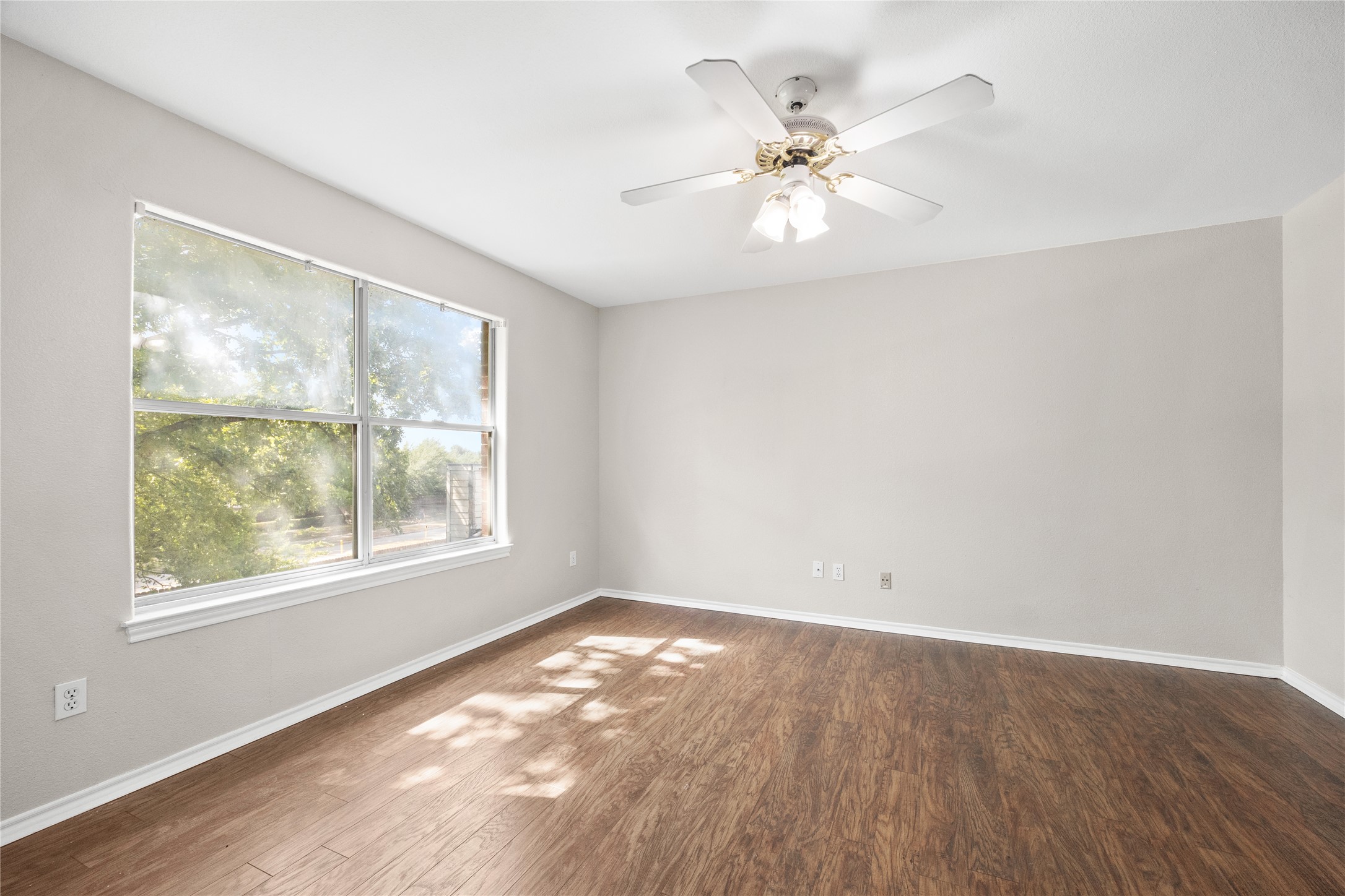 13217 Rochester Lane Austin, TX 78753 - Photo 20 of 30 Rich wood flooring anchors this inviting space illuminated by a wide window framing leafy views.