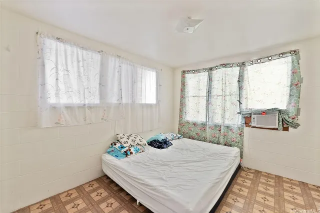 a bed sitting in a bedroom next to a window