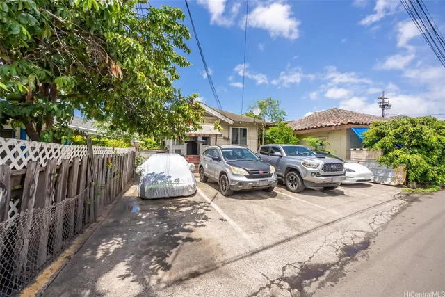 a couple of cars parked in front of a house