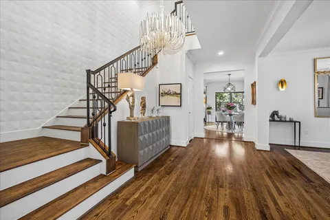 a view of entryway and hall with wooden floor