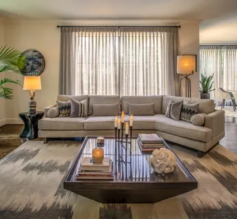 a living room with furniture a fireplace and a large window