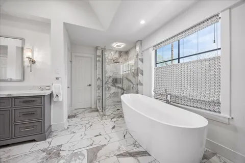 a spacious bathroom with a double vanity sink mirror and double