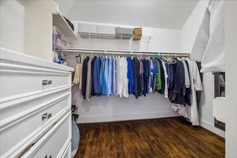 a view of walk in closet with clothes