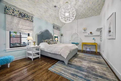 a bedroom with a bed and a chandelier