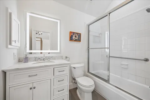 a bedroom with a bed couch and a window