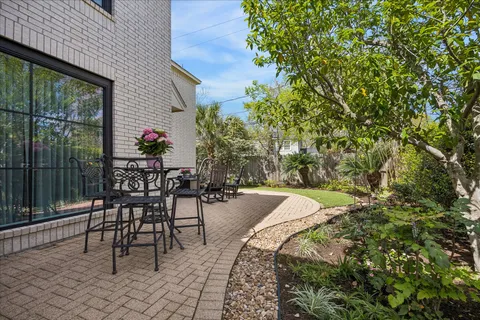 a view of a patio with table and chairs and potted plants