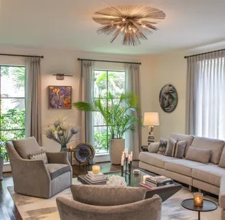 a living room with furniture a chandelier and a large window