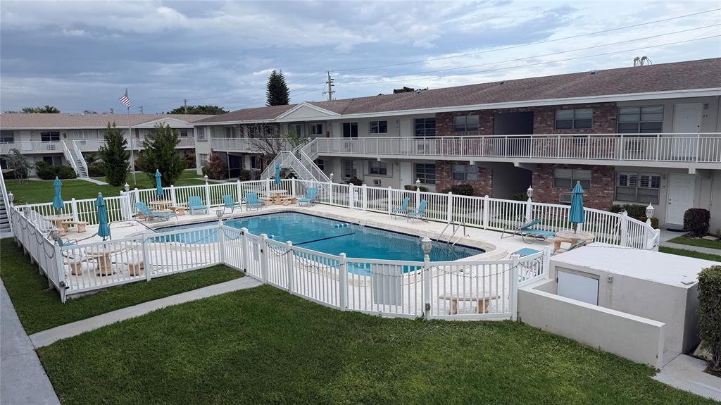 3850 Northeast 21st Way, Unit 62 Lighthouse Point, FL 33064 - Photo 12 of 13 a view of a house with pool and chairs