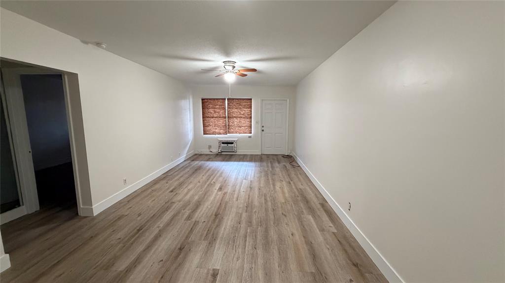 3850 Northeast 21st Way, Unit 62 Lighthouse Point, FL 33064 - Photo 3 of 13 wooden floor in an empty room with a window