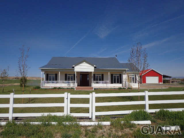 1427 19 Road Fruita, CO 81521 - Photo 3 of 23 a front view of a house with a yard