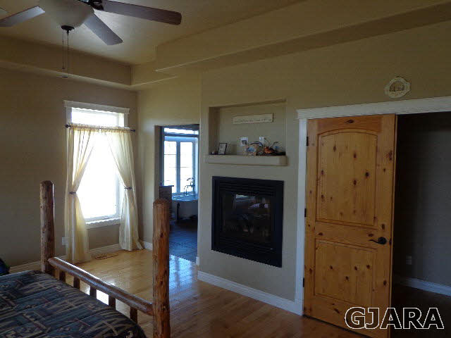 1427 19 Road Fruita, CO 81521 - Photo 8 of 23 a living room with a fireplace and a table