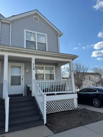 front view of a house with a bench