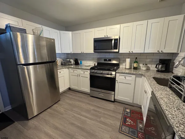 a kitchen with a refrigerator sink and microwave